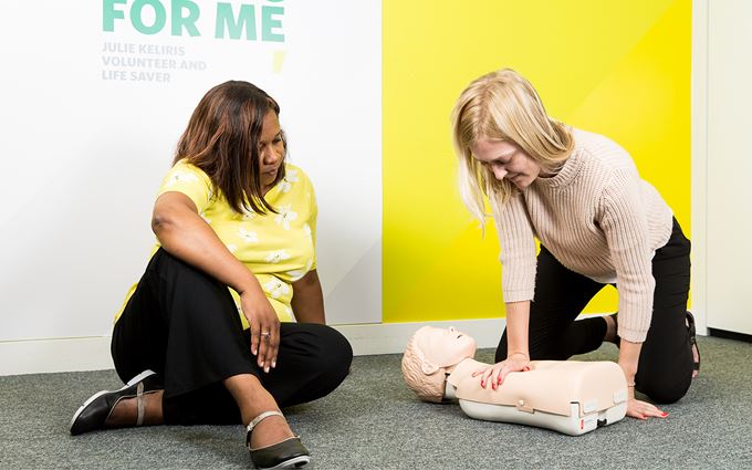 Course participants practicing child CPR using a training mannequin Course participants practicing child CPR using a training mannequin