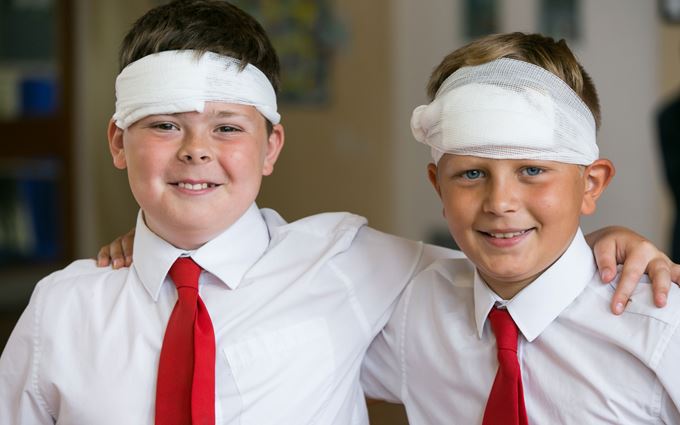 Two school children with bandages on their heads