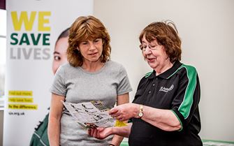 First Aid Community Advocate talking to a woman