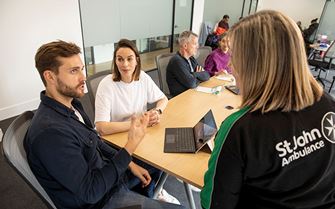 Training small pod talking at table