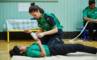 Cadets practising arm bandaging