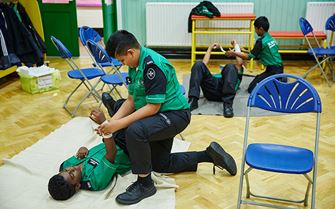 Cadets practising arm bandaging
